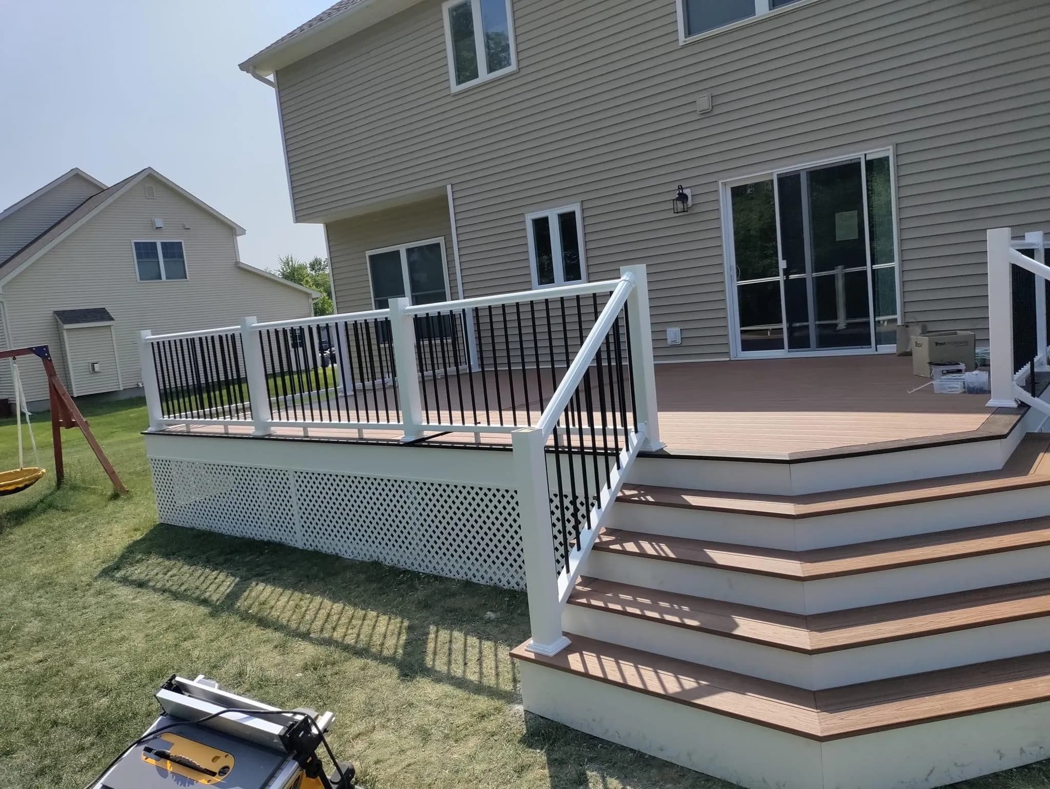 Composite deck with wide entry steps and white railings