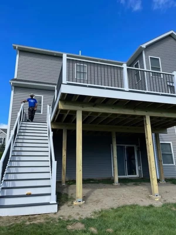 Second-story deck with wooden posts mid-construction