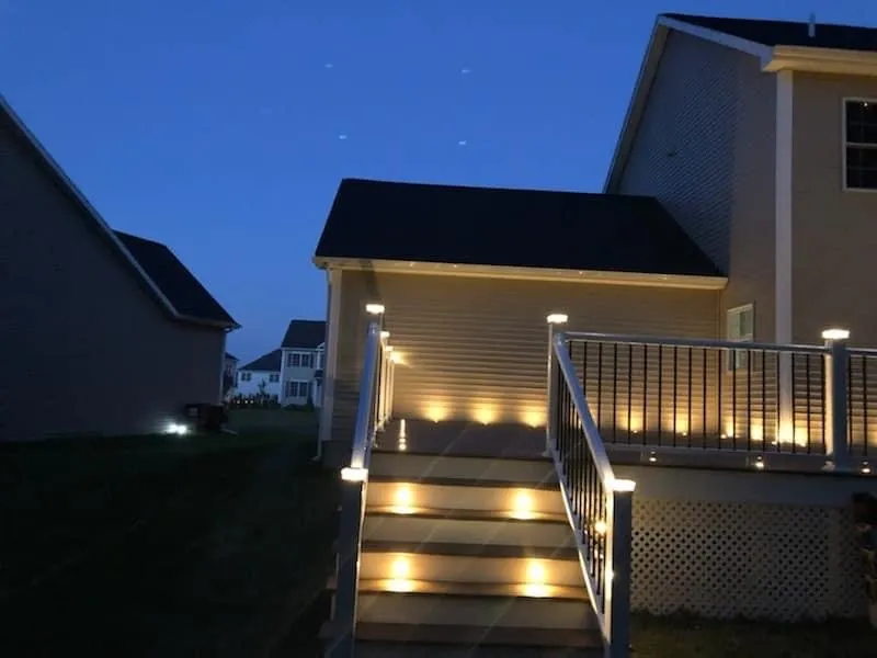Composite deck at night with warm post cap lighting