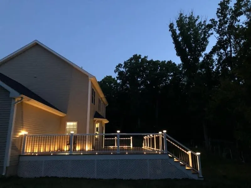 Illuminated deck stairs and railings at dusk