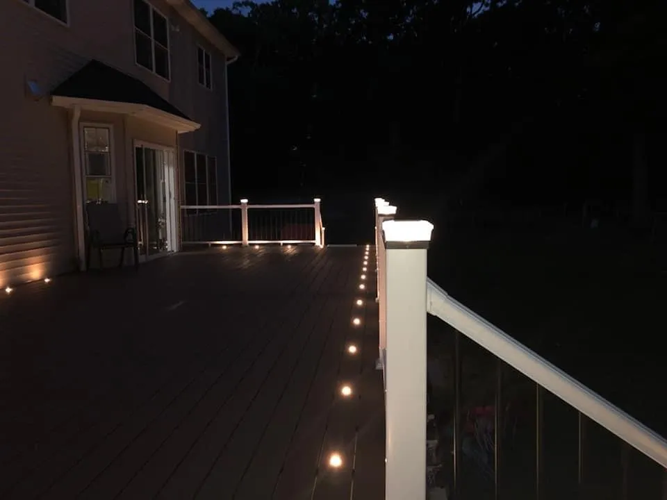 Composite deck at night with railing and floor lights