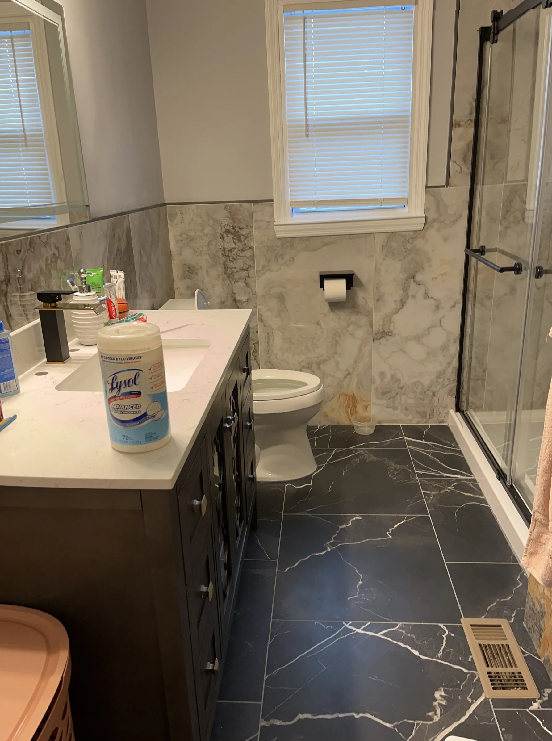 Marble bathroom with dark tile floor and modern vanity