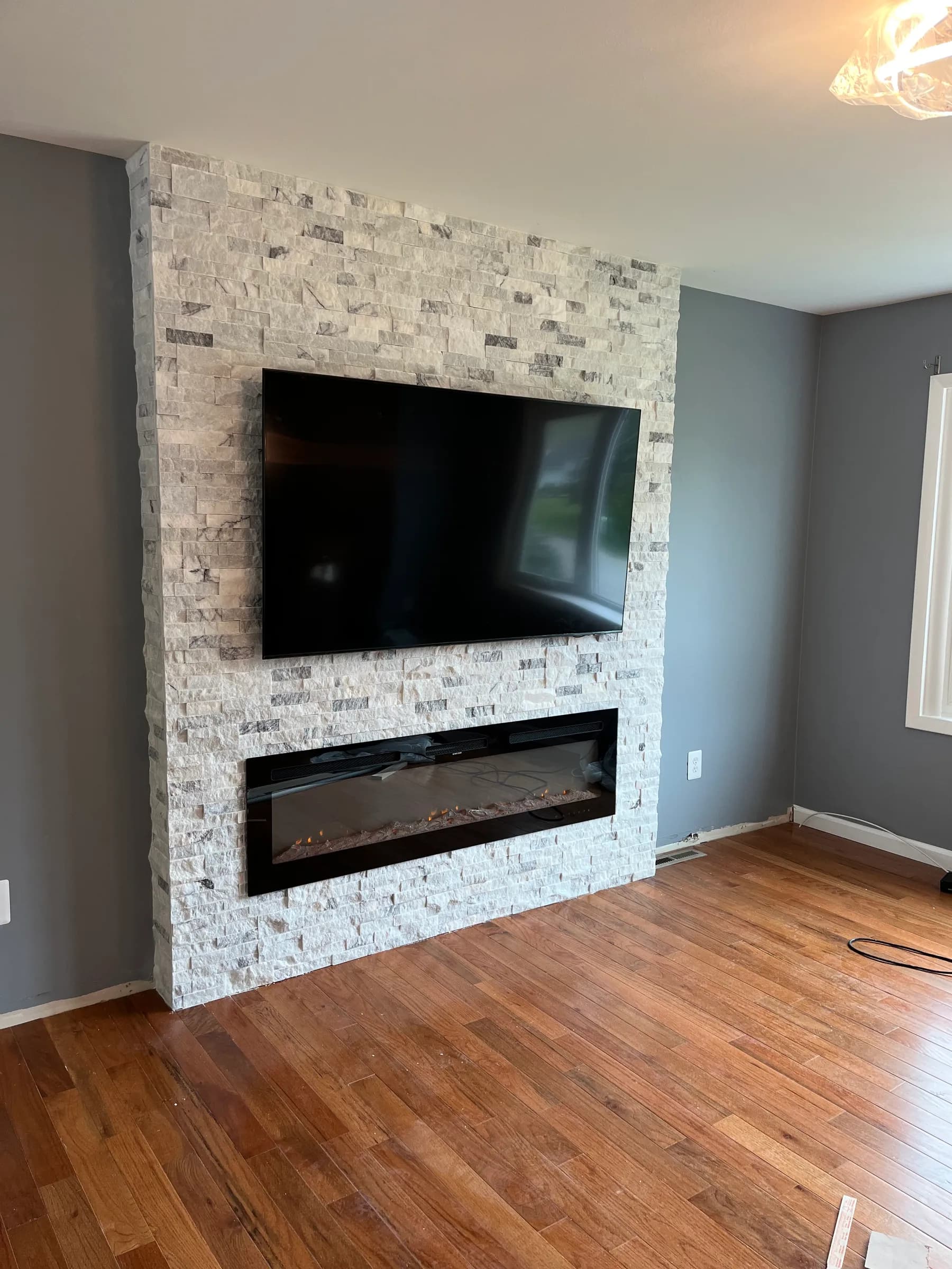 Angled view of stone feature wall with hardwood floor
