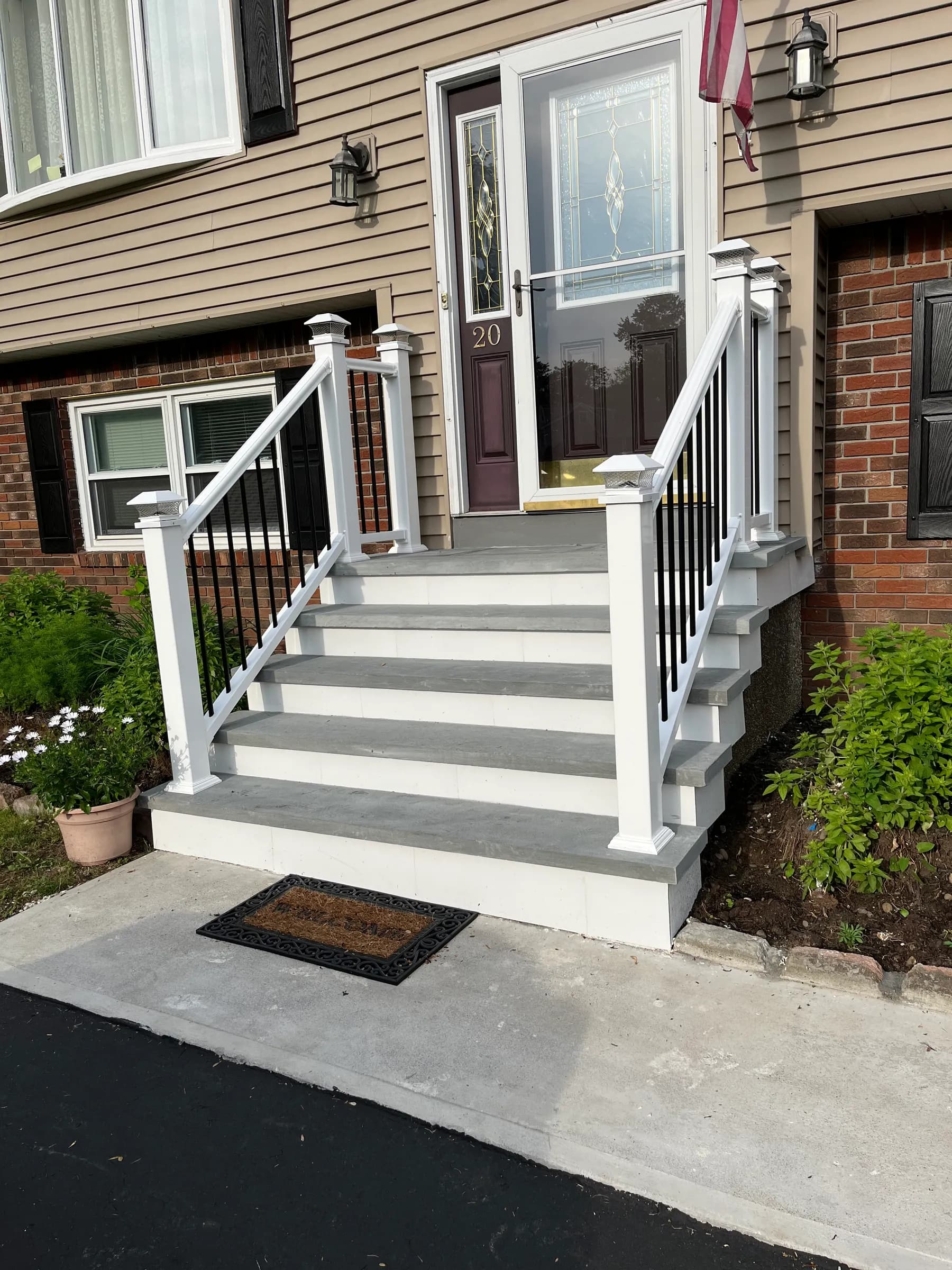 Front porch with white columns and stairs