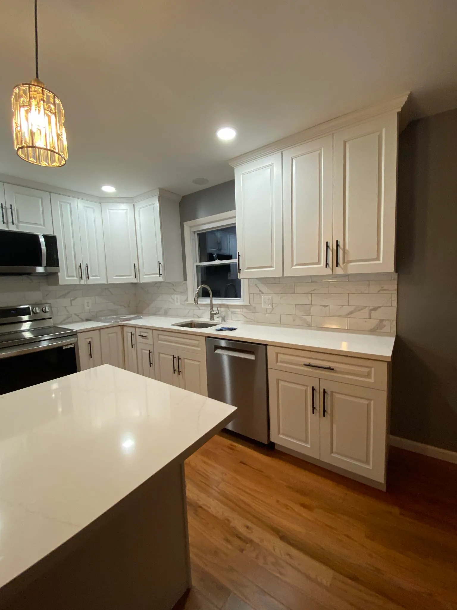 Kitchen with marble subway backsplash and dishwasher