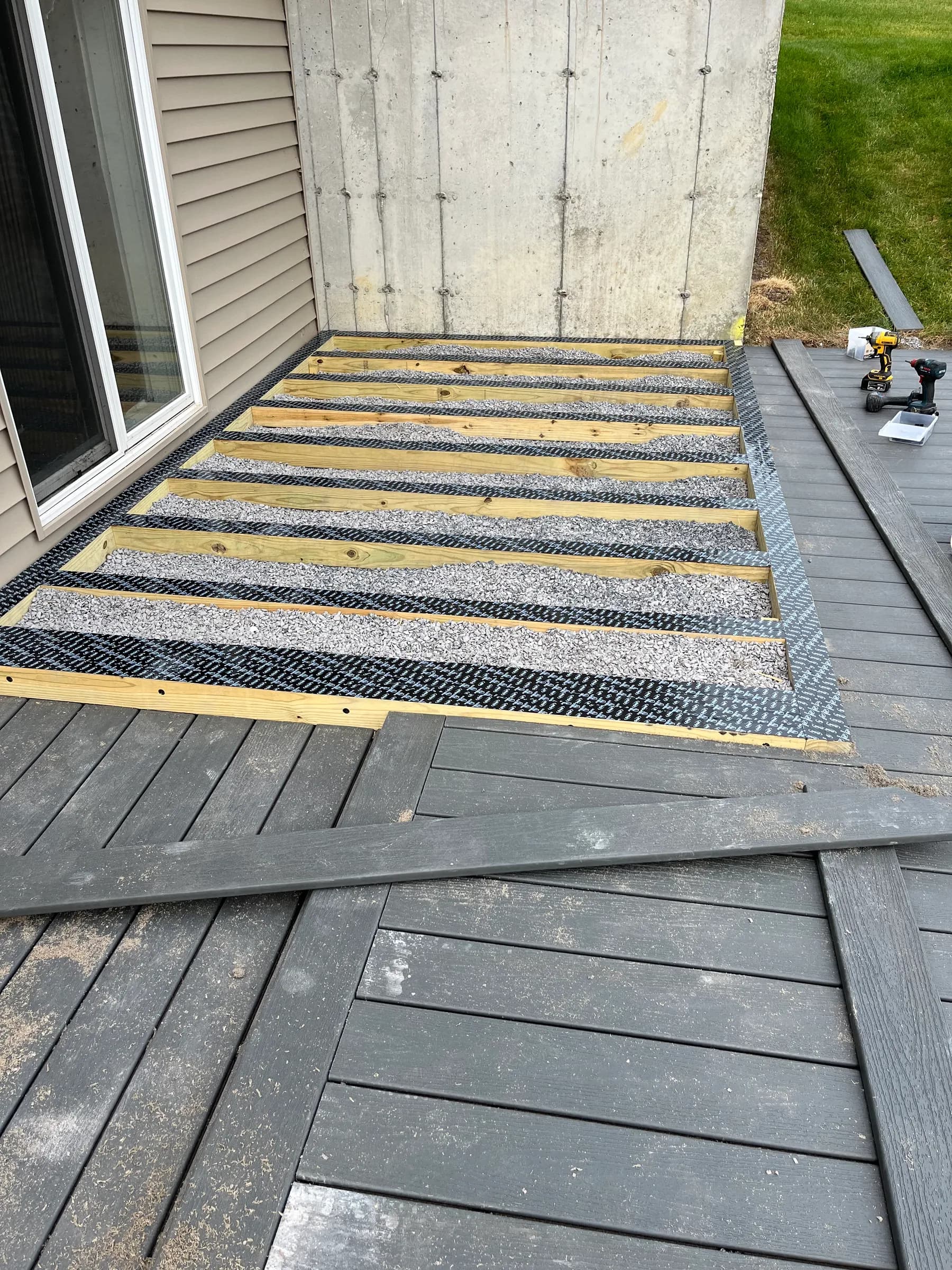 Charcoal wood privacy fence panels with stone pillar