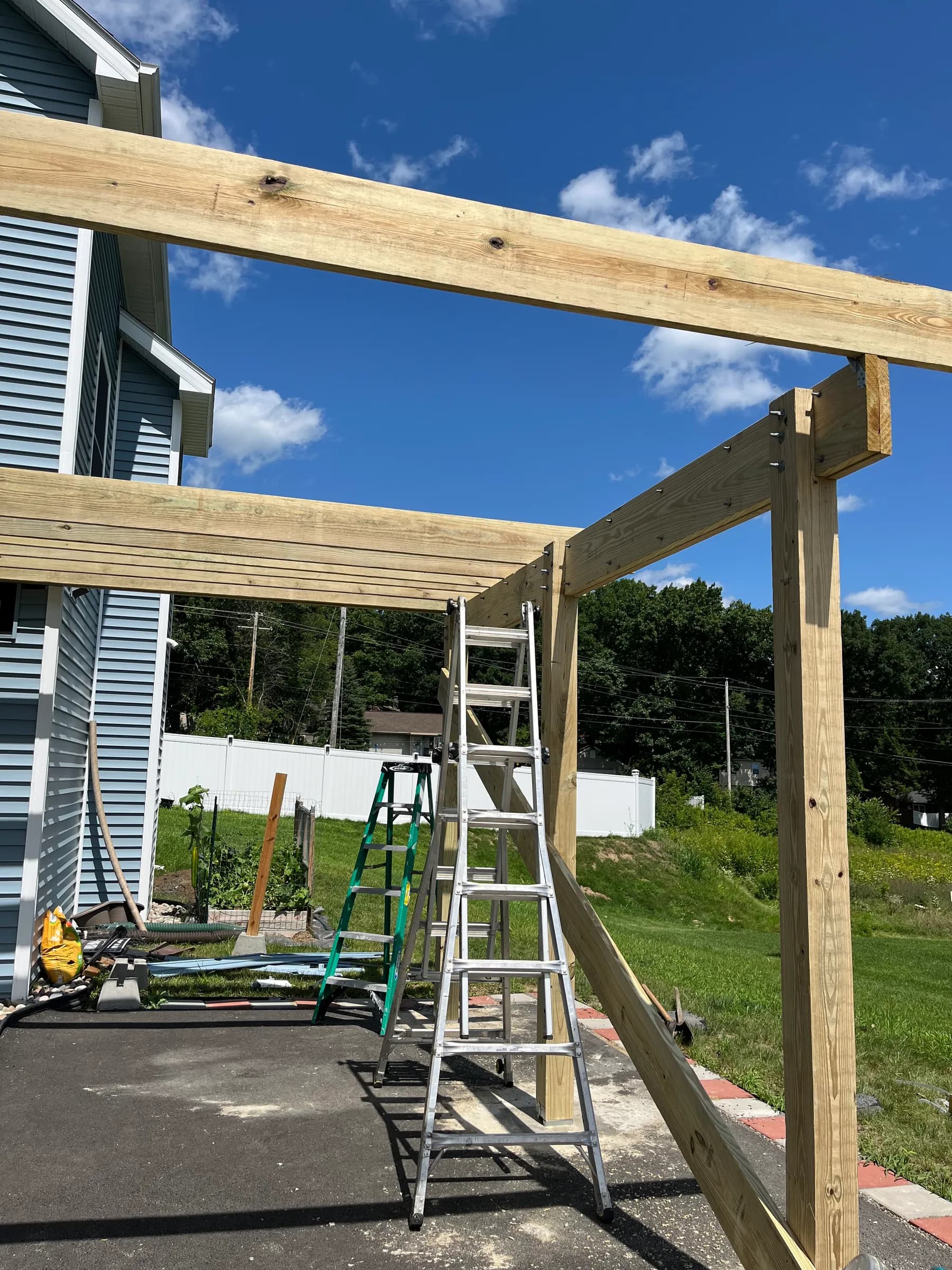 Pergola framing in progress above carport