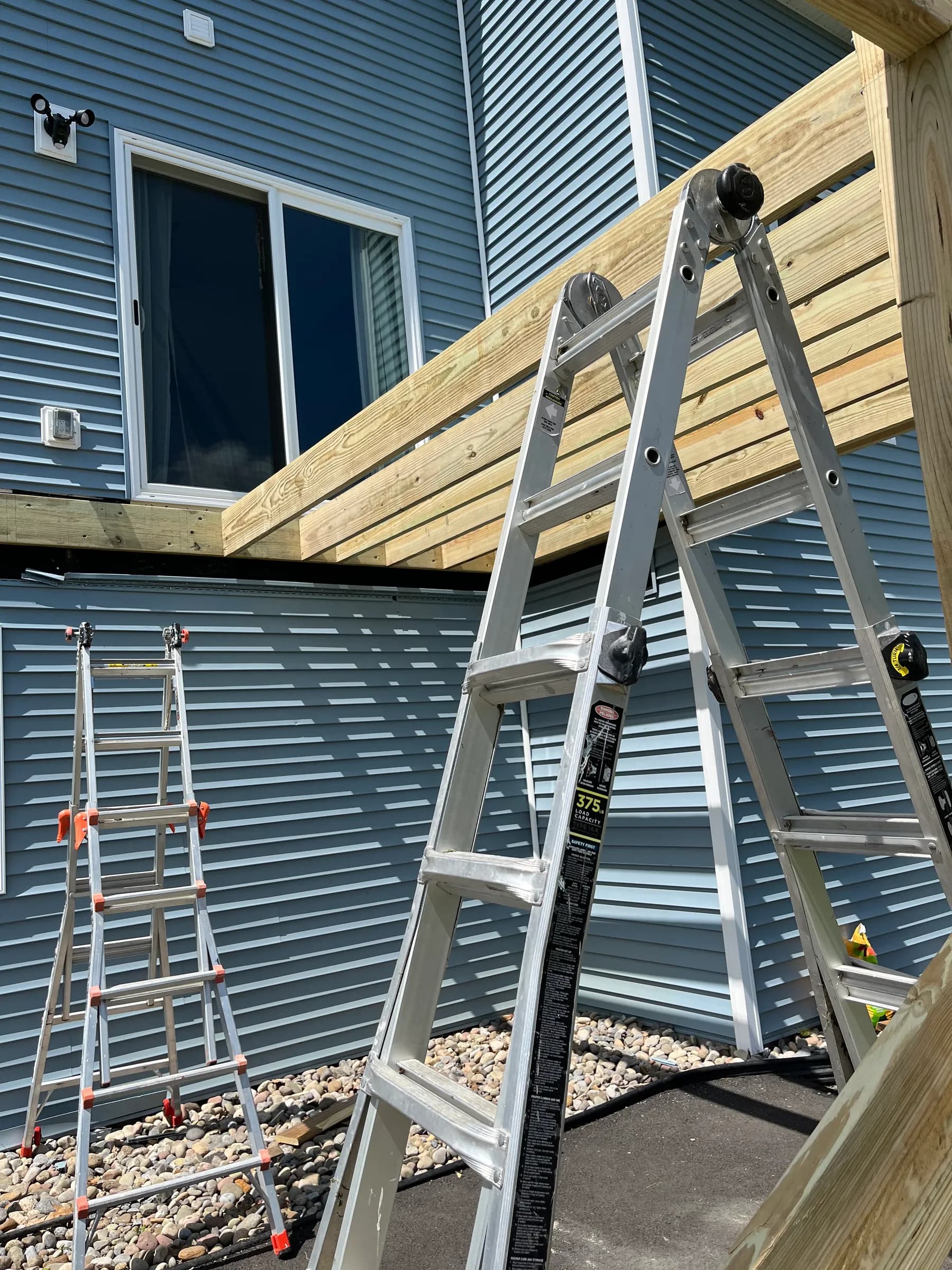 Ladder on metal roof during pergola construction
