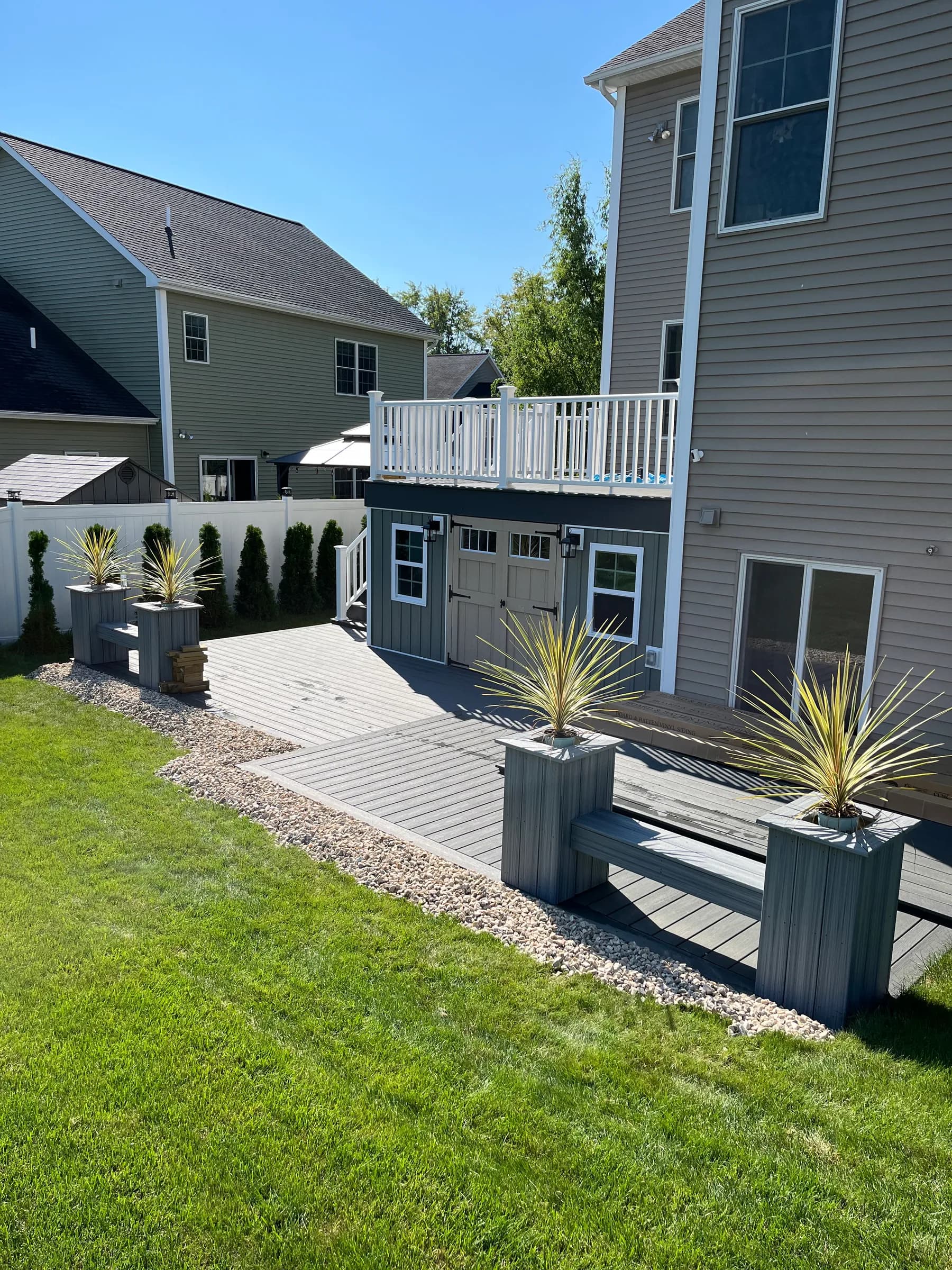 Elevated deck with palm plants and aluminum railings