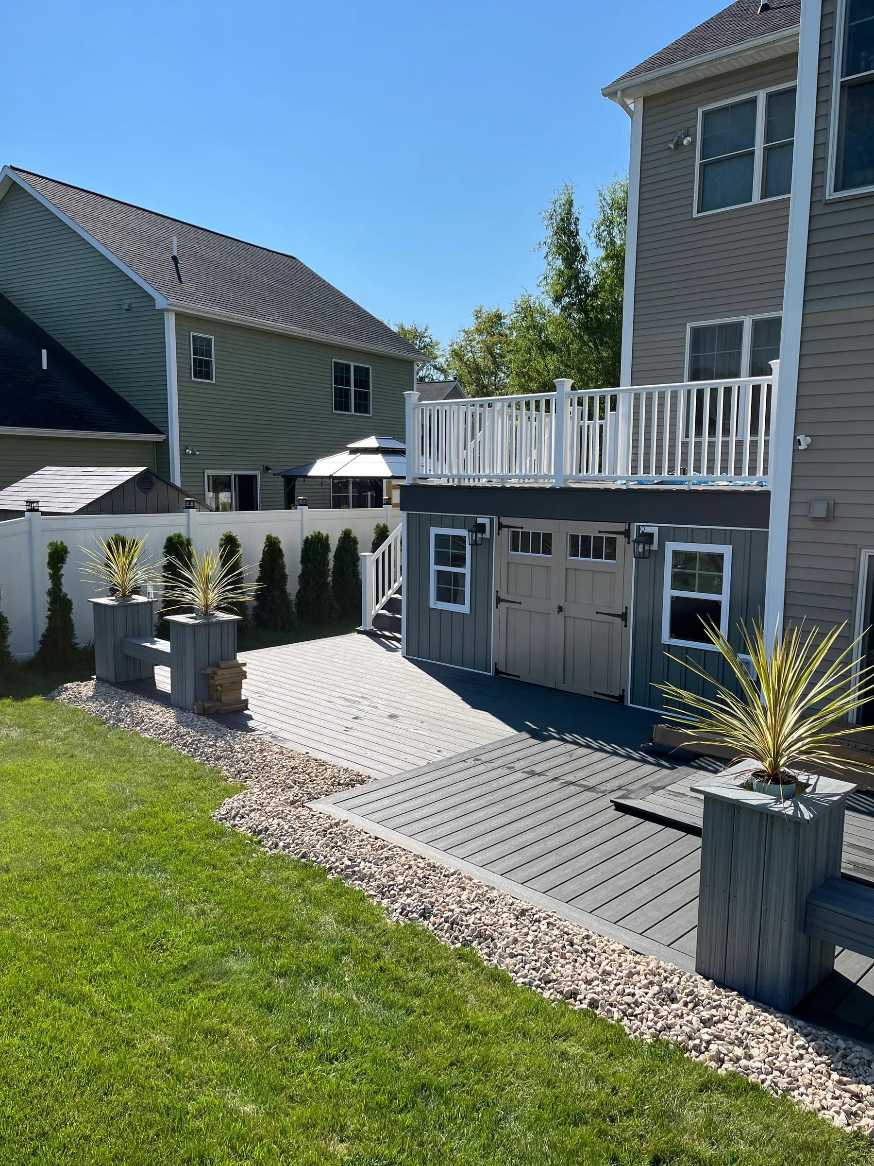 Side view of composite deck on beige house