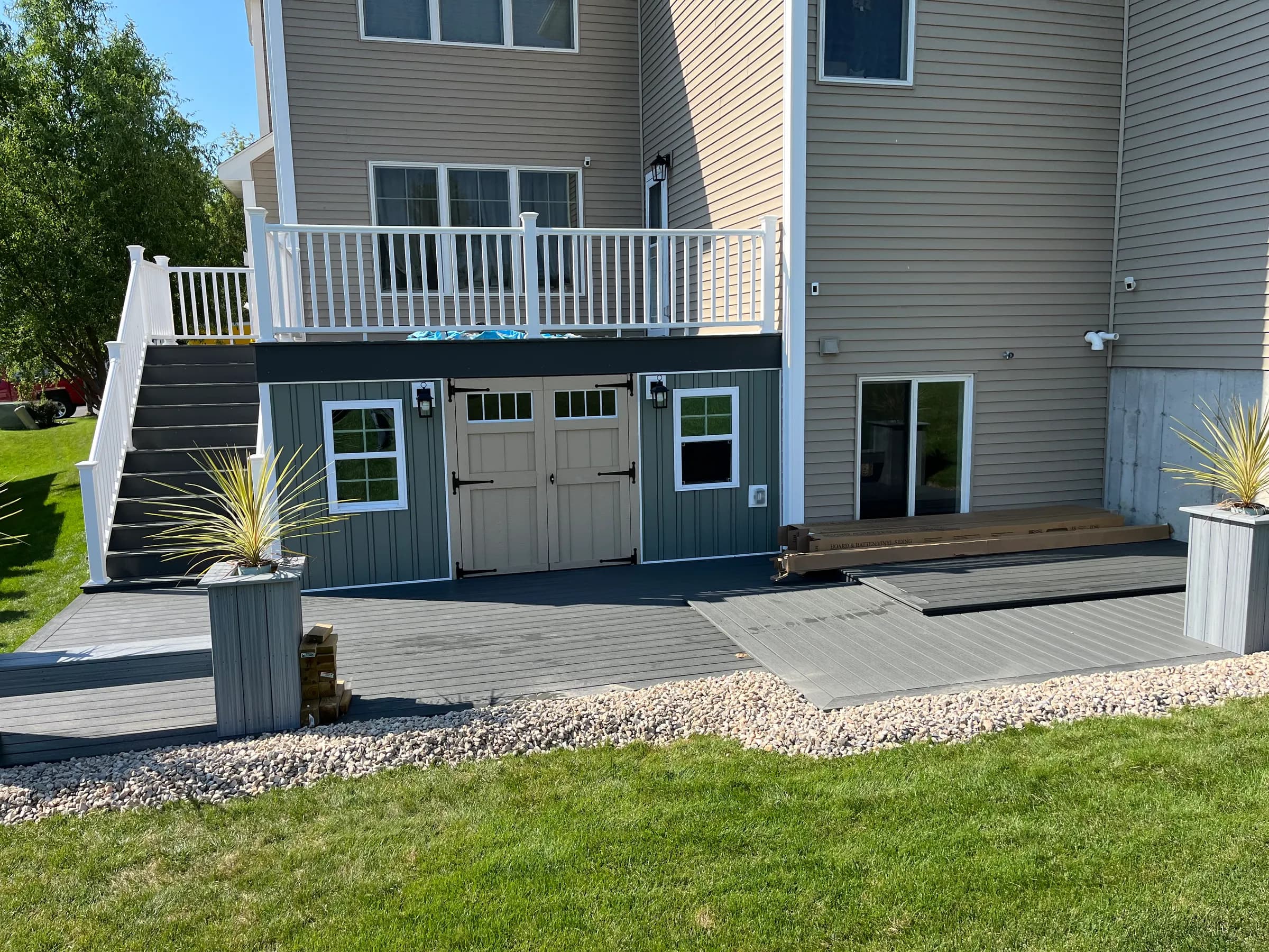 Two-tier deck with upper balcony and lower patio
