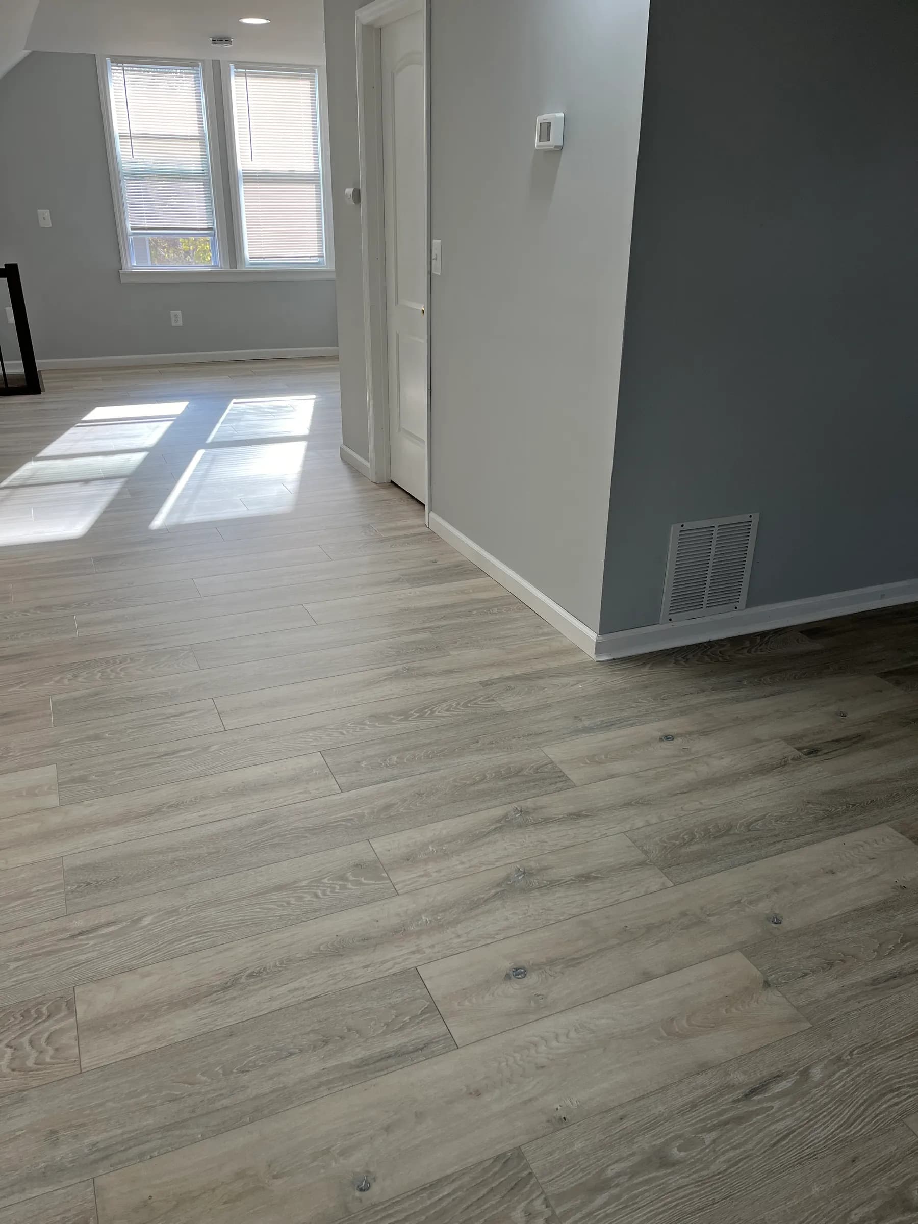 Gray wood-plank flooring in newly built room