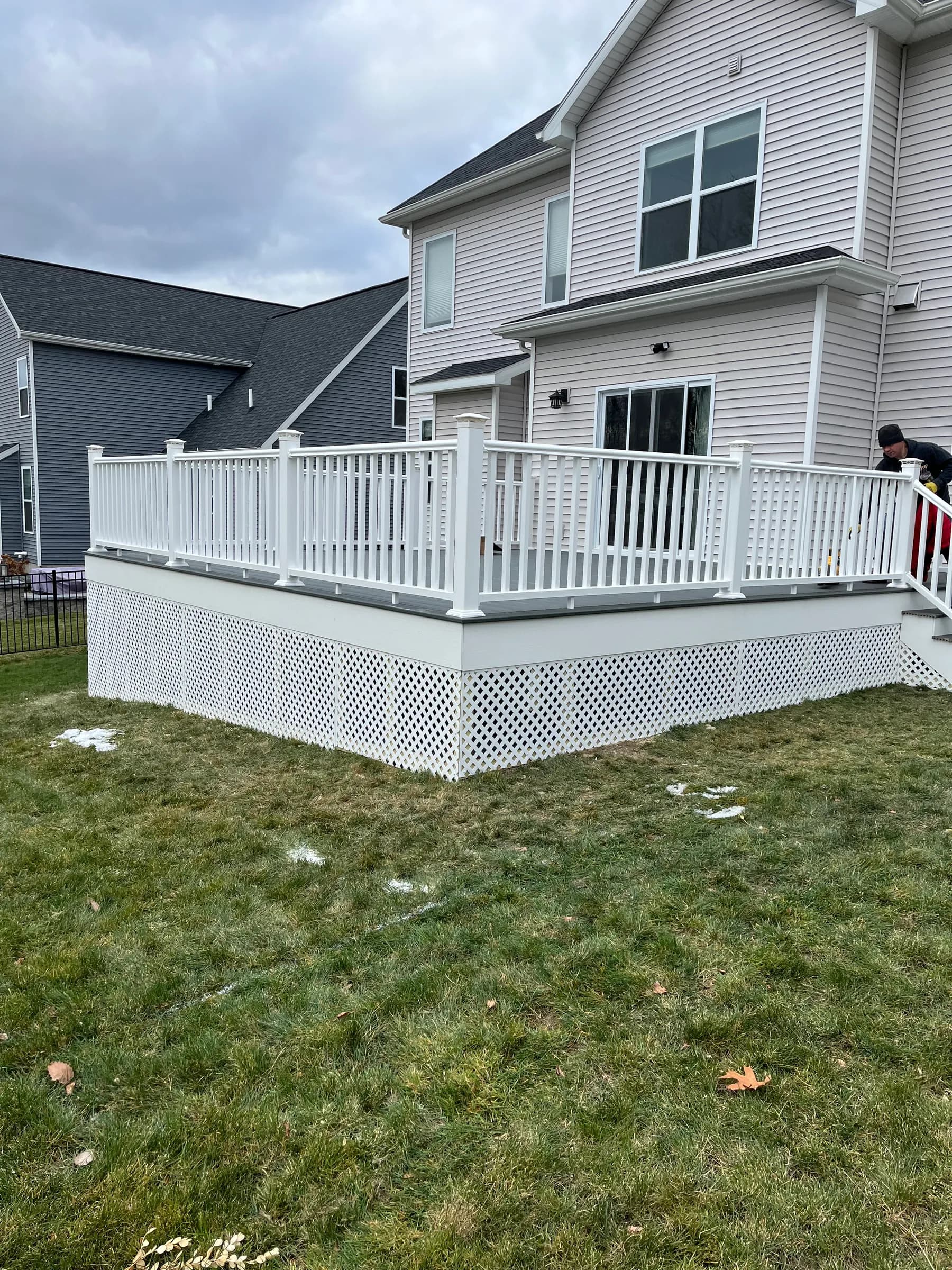 White deck with white stairs on light siding home