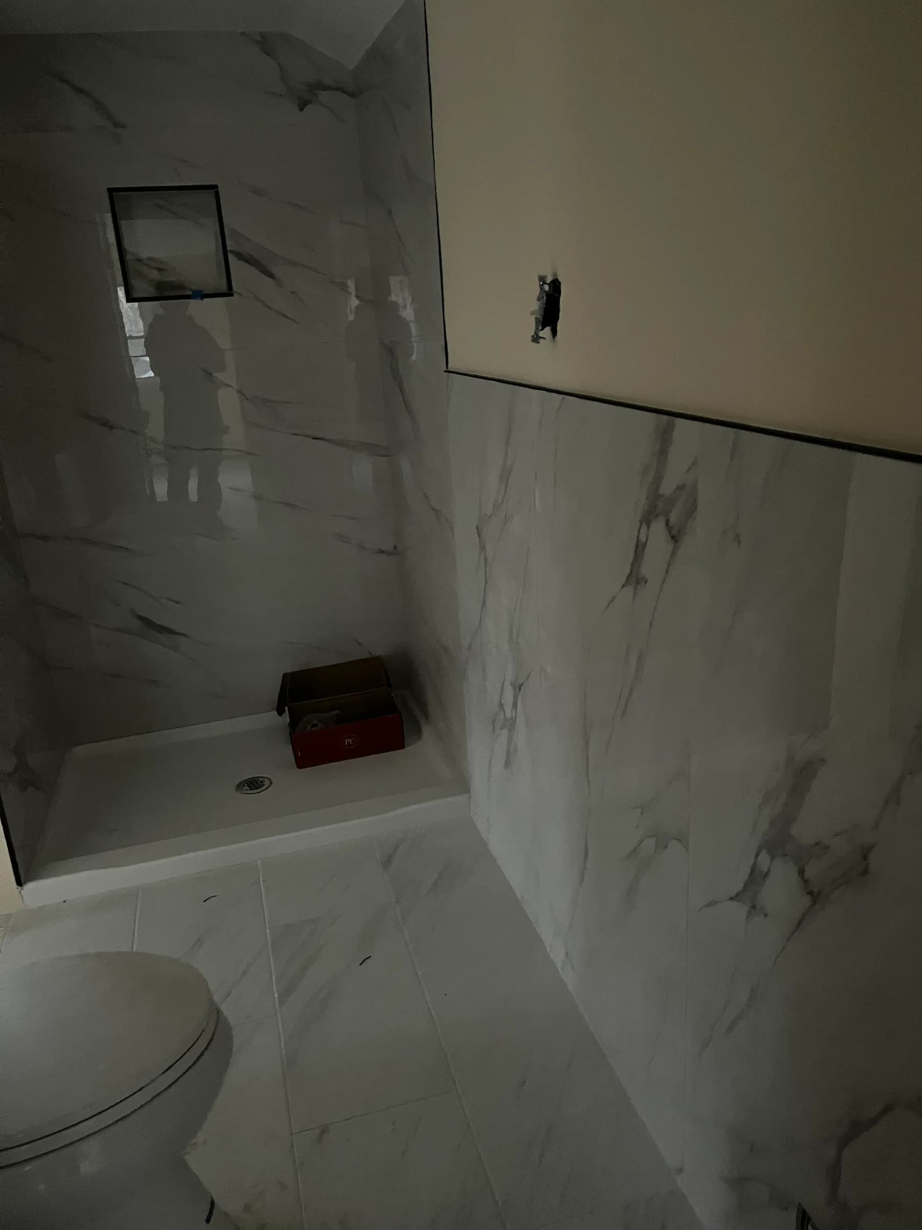 White marble shower construction in progress