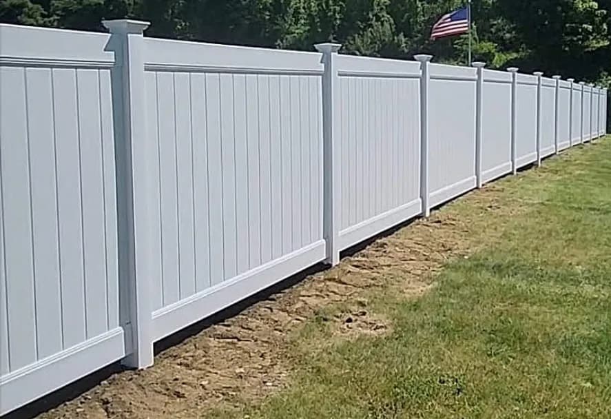 White vinyl privacy fence line with American flag