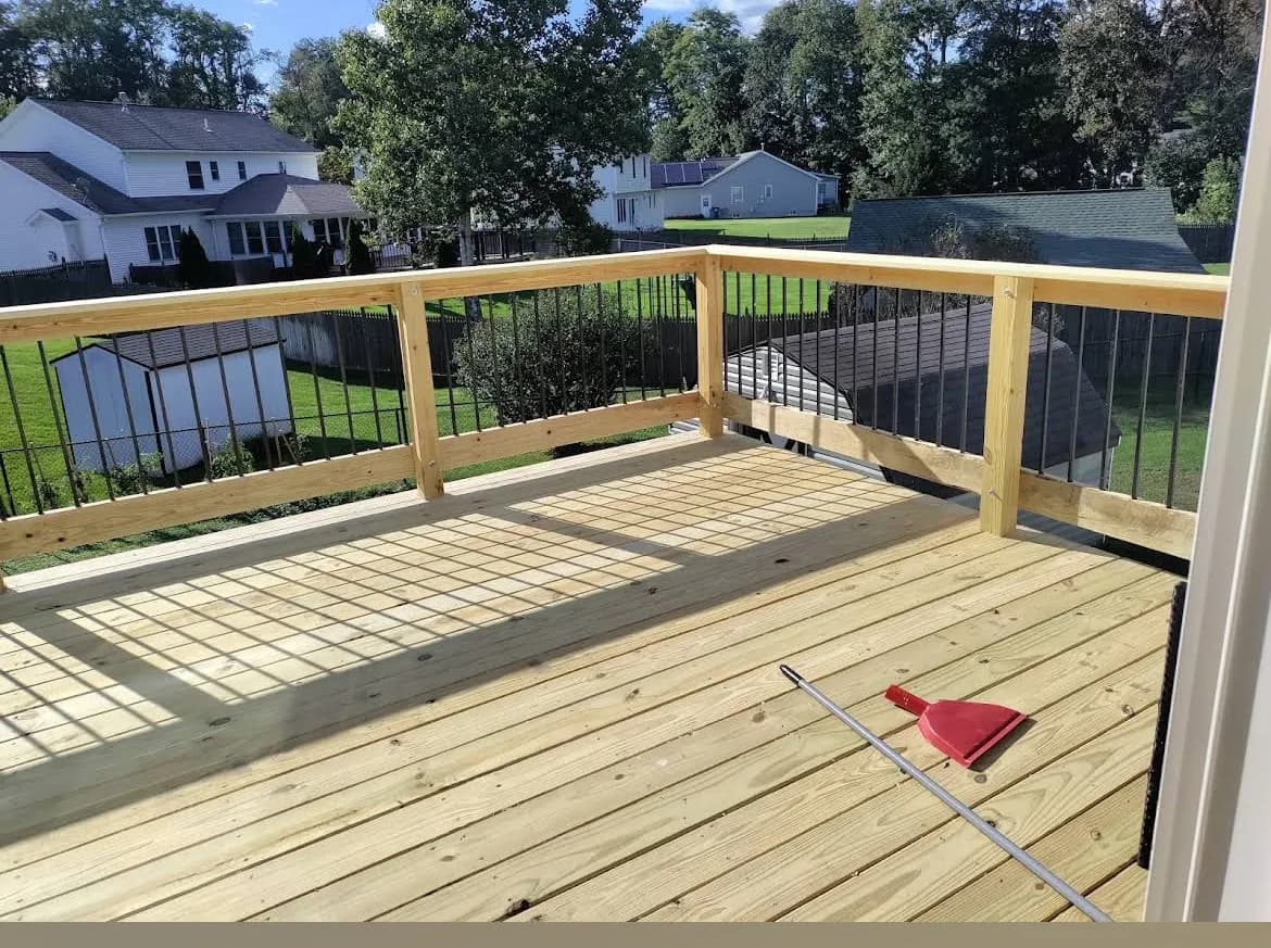 New wooden deck framing with black railings overview