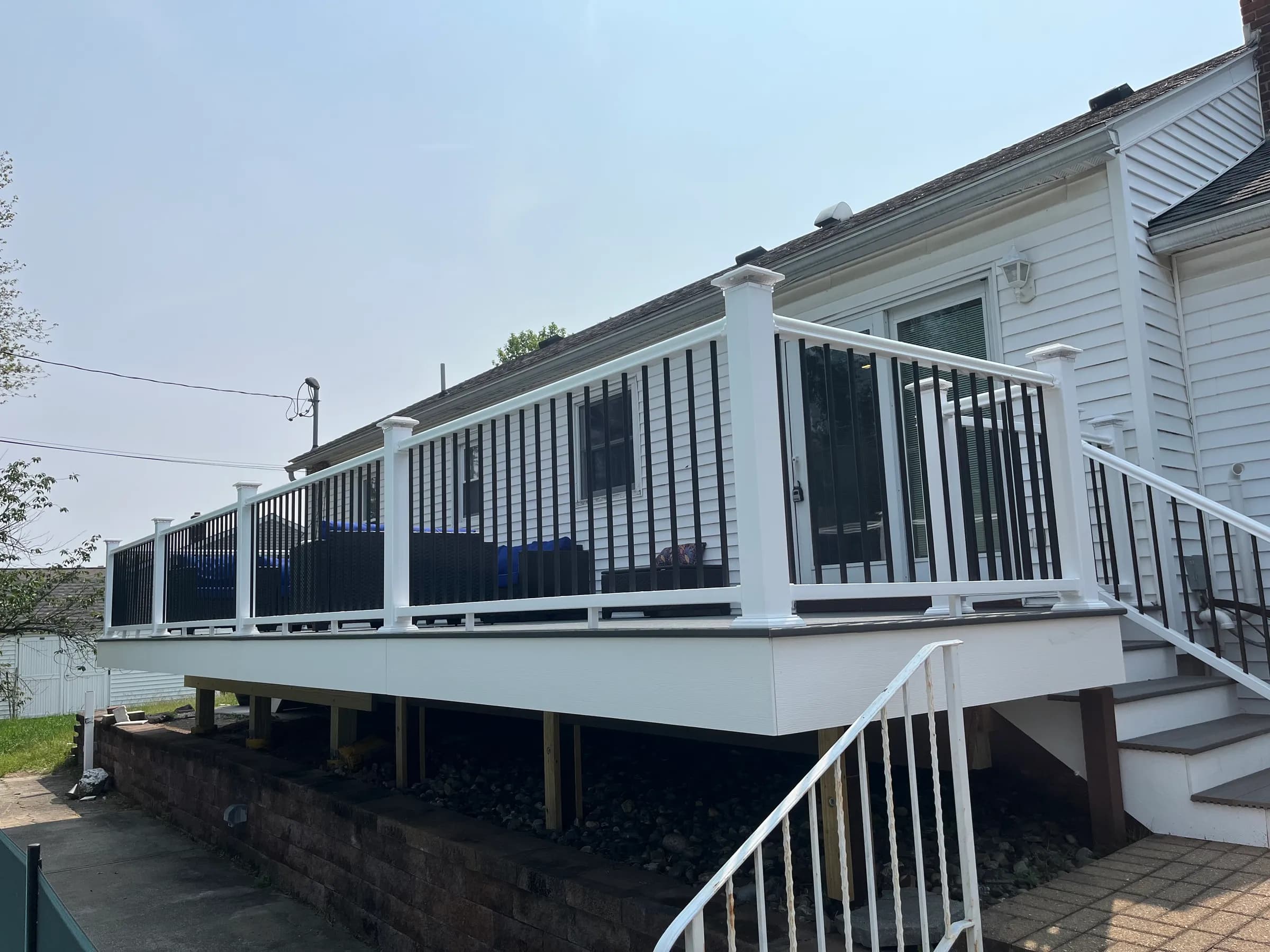 Elevated white deck side view with black balusters