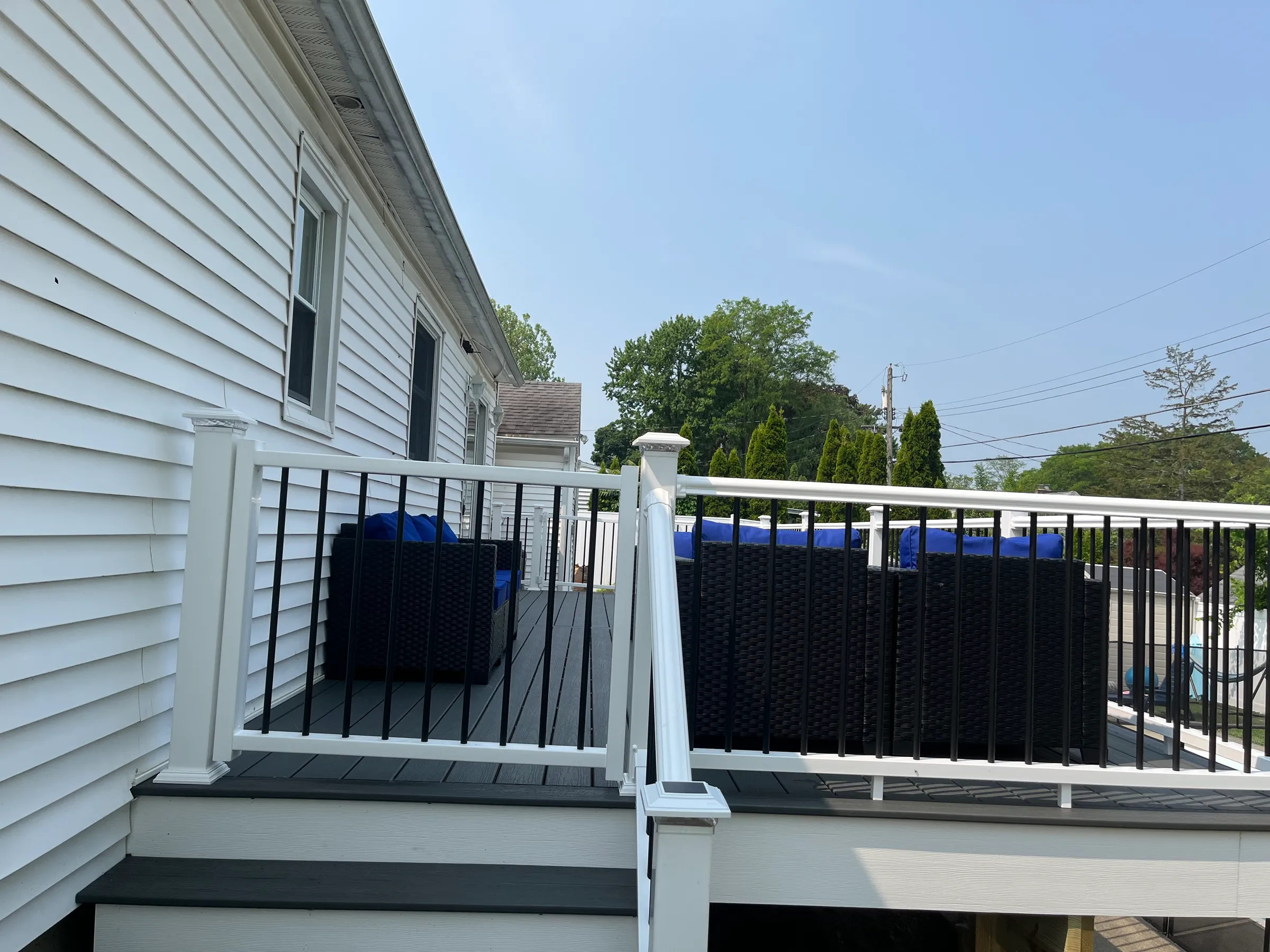 White railings with black balusters on side deck