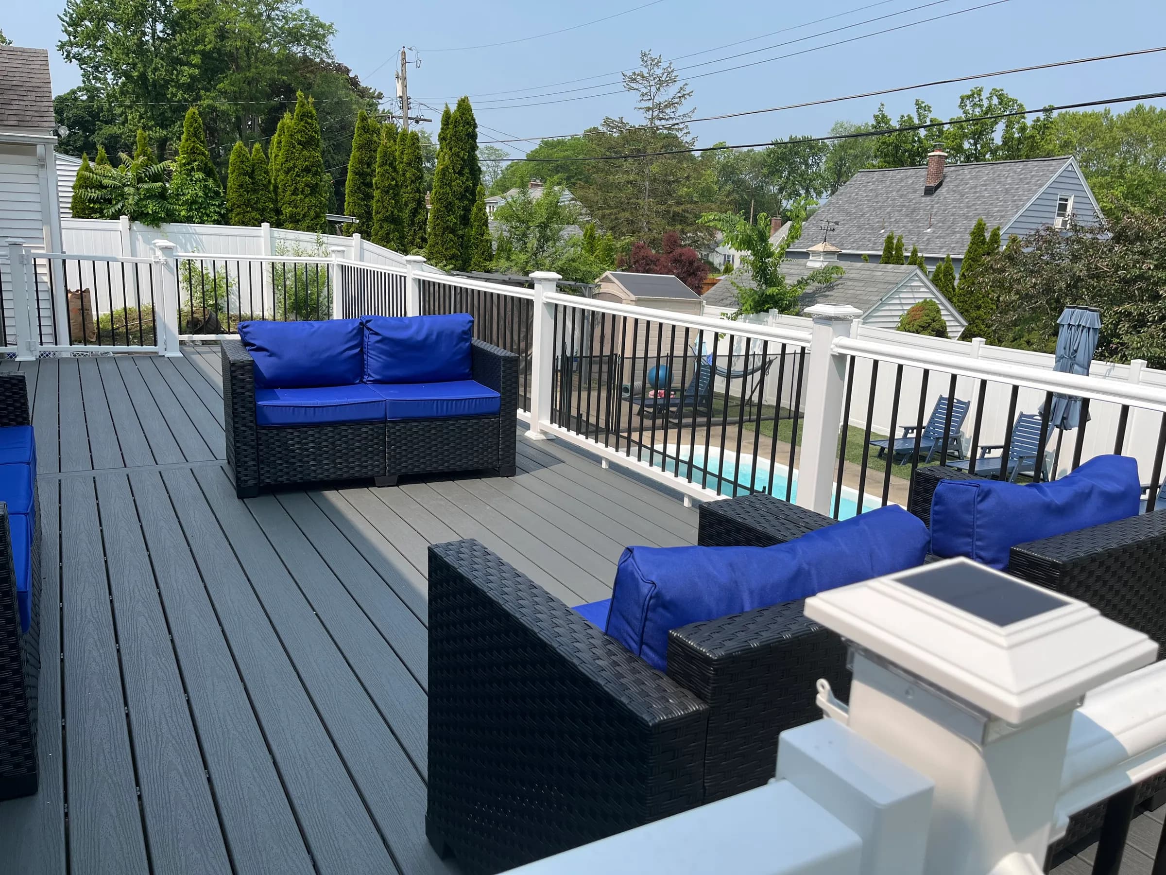 Deck with outdoor furniture overlooking inground pool