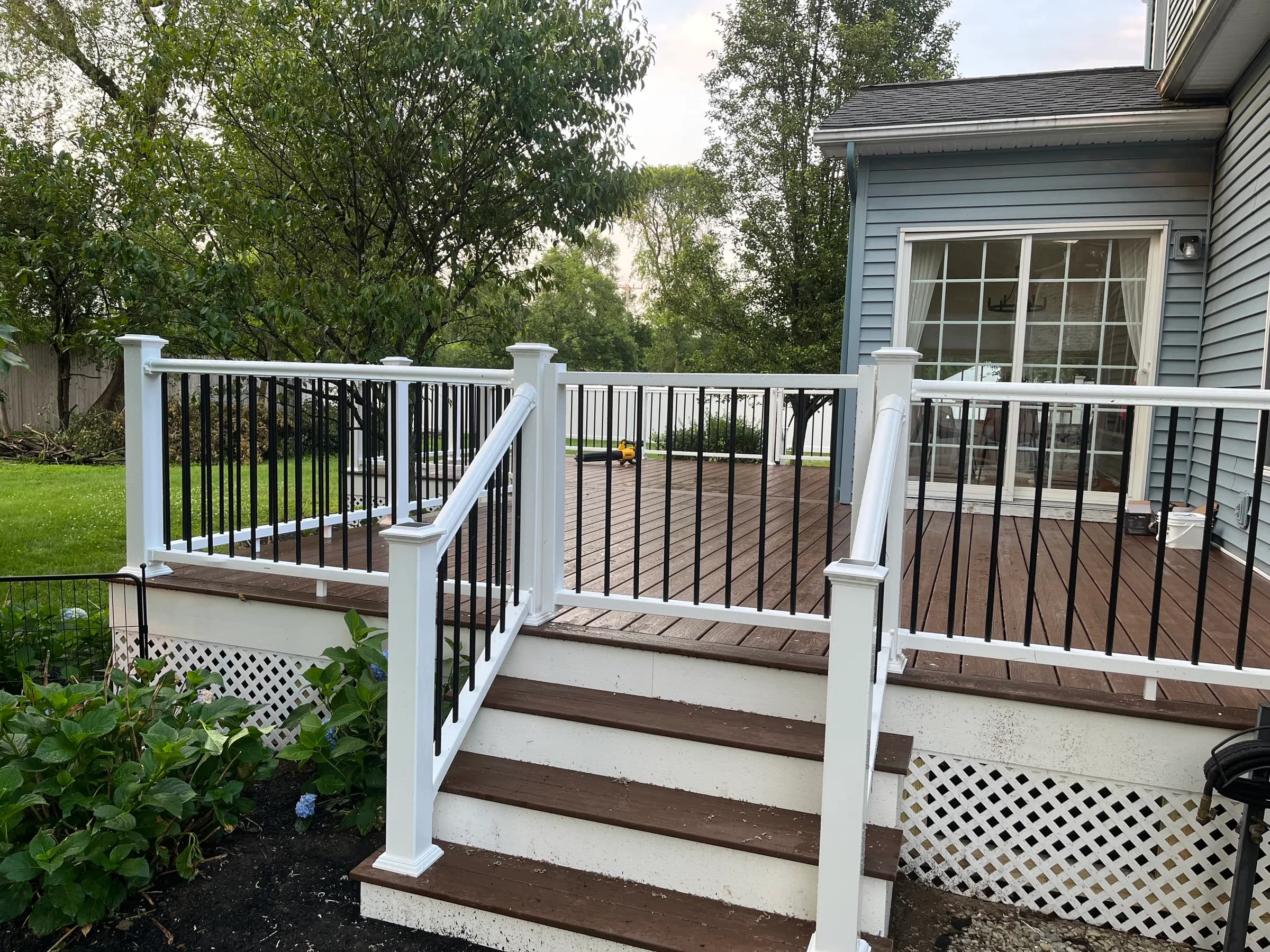 Brown deck with stairs and white railings
