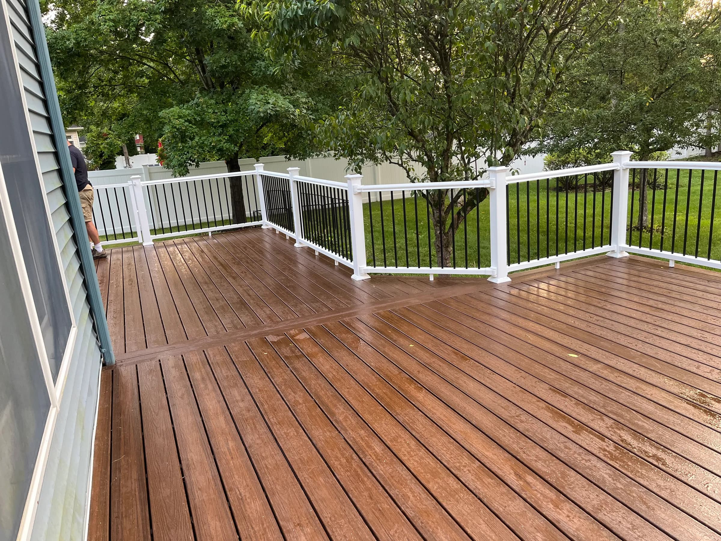 Brown composite deck floor with pergola shade