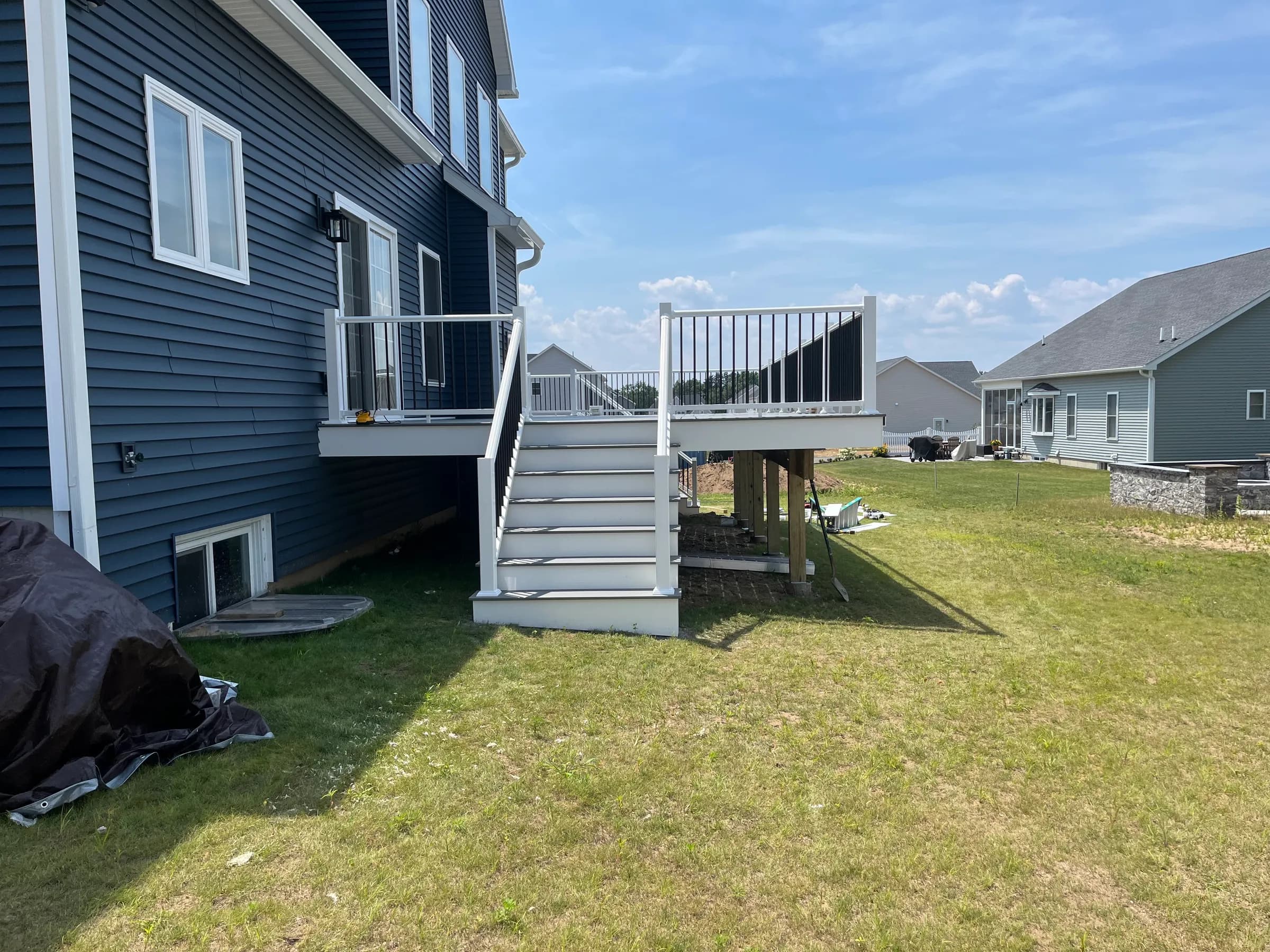 Side view of white elevated deck with stair access
