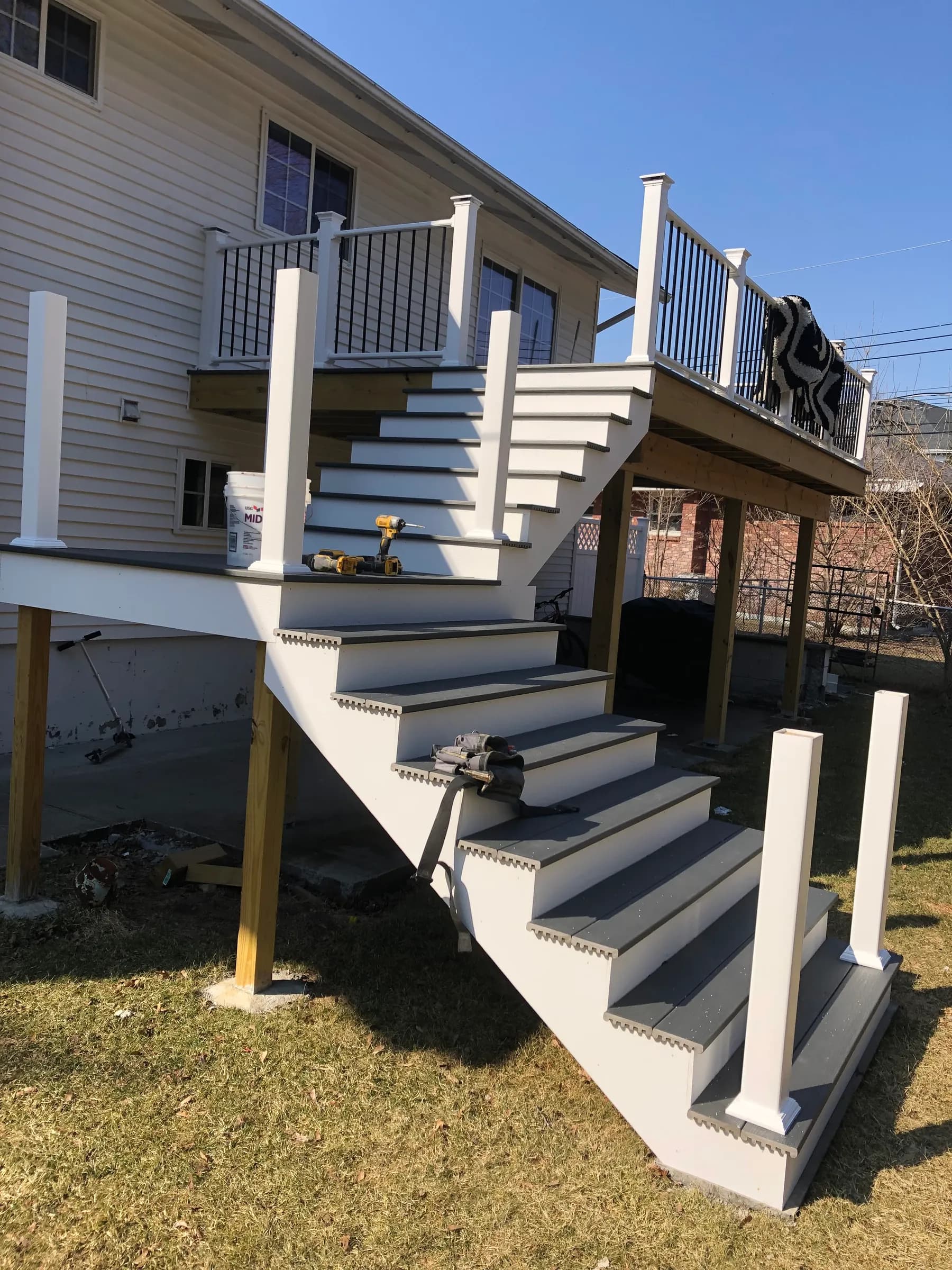 White deck with stairs in winter snow