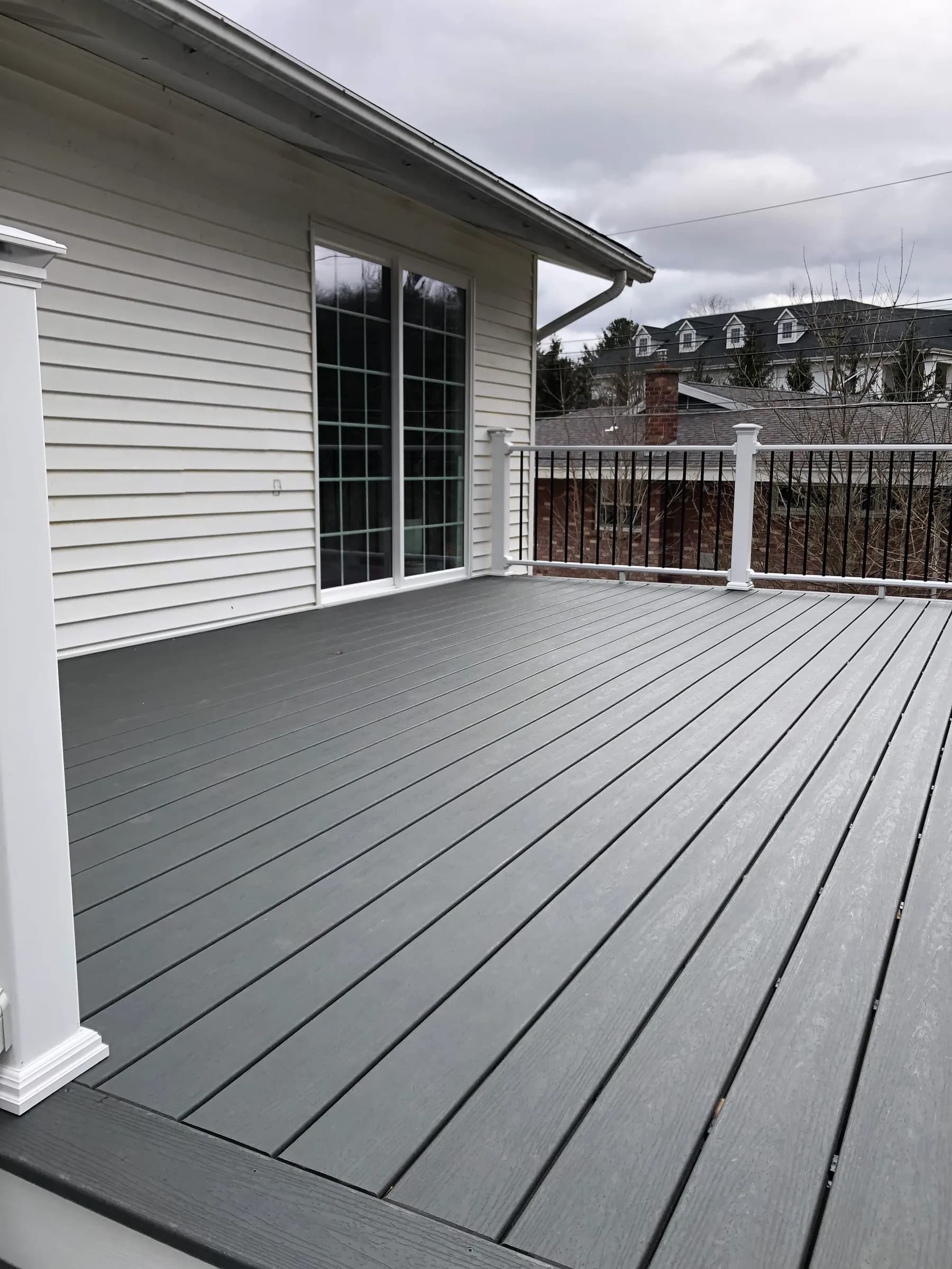 Gray composite side deck on gray siding home