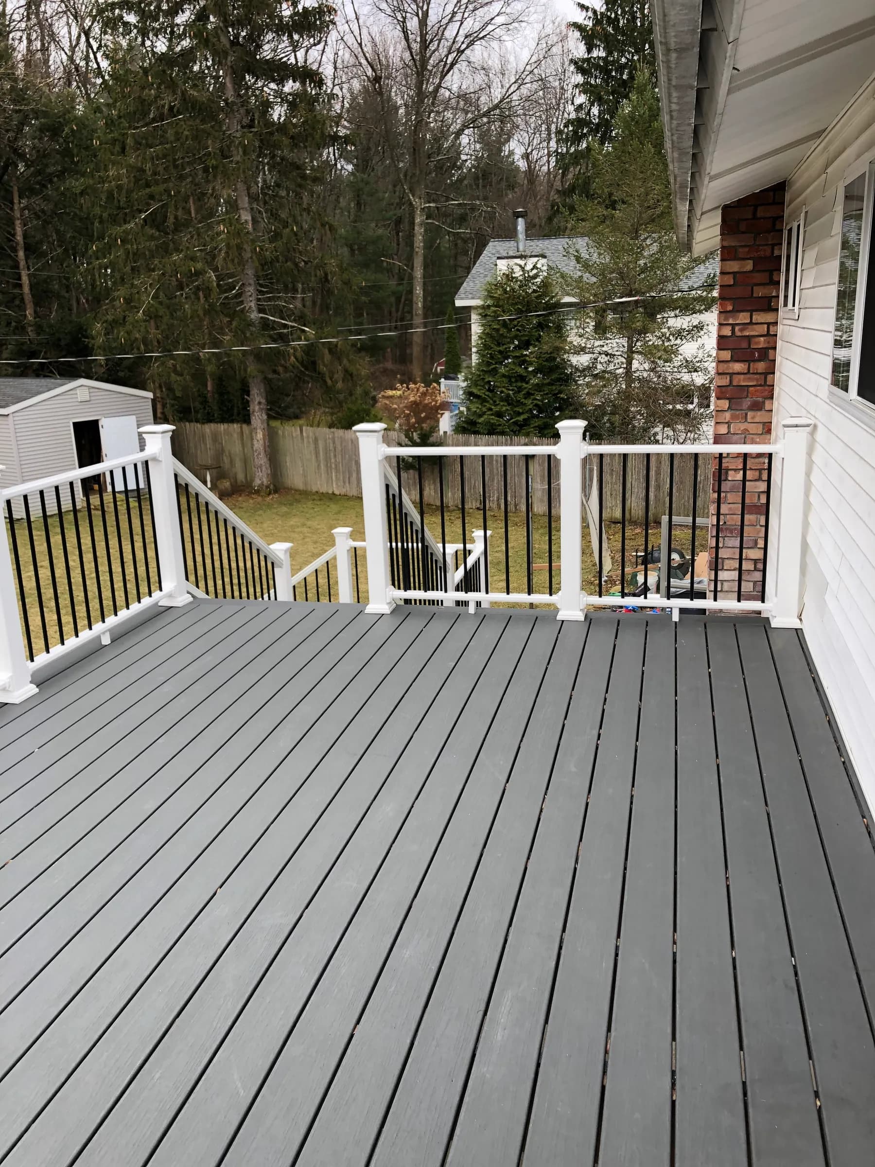 Elevated gray deck with white railings