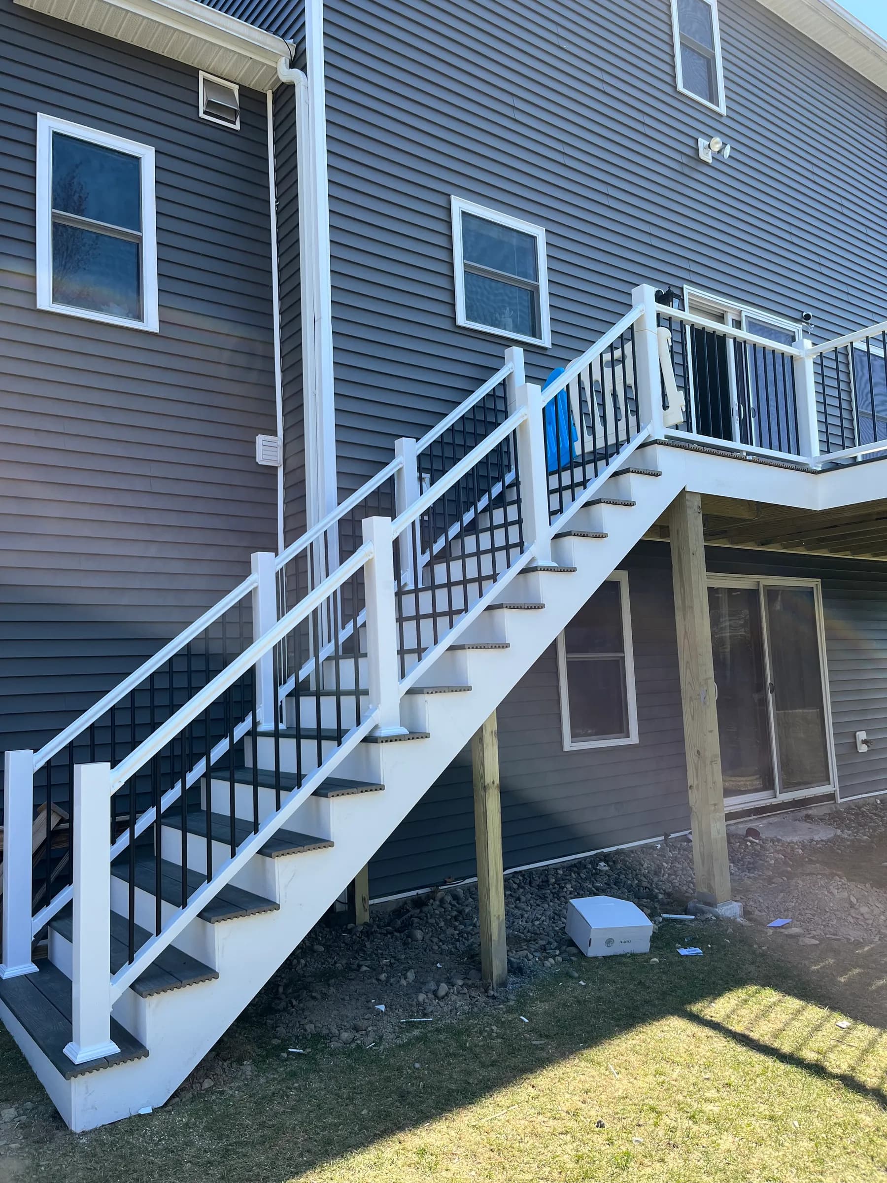 Elevated deck with long staircase to yard