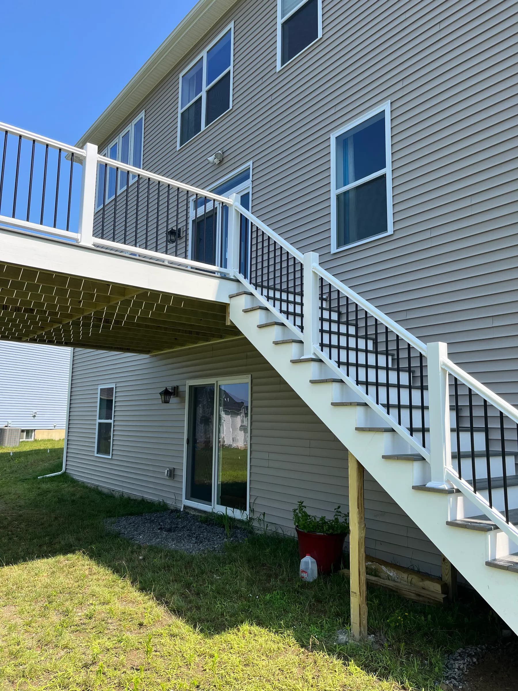 White pergola over elevated composite deck