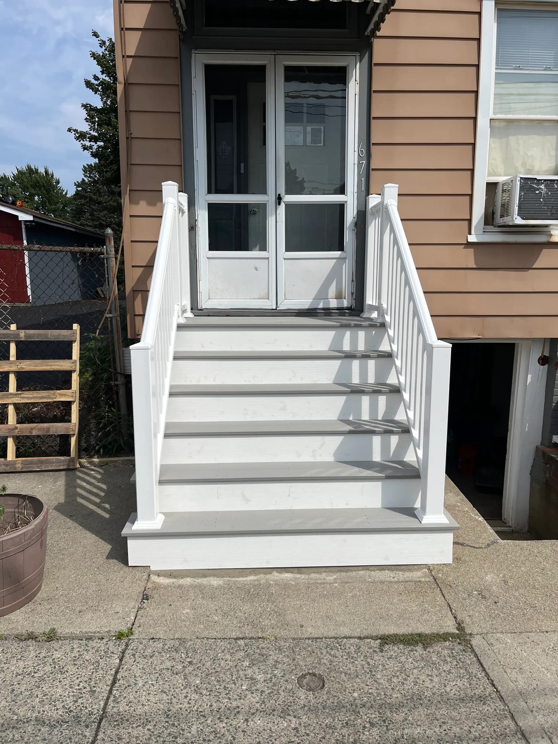 White pergola canopy over front entry doorway